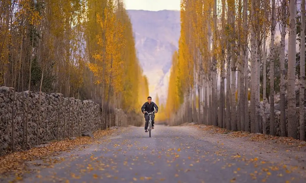 A YOUNG BOY RIDING HIS BIKE IN KHAPLU